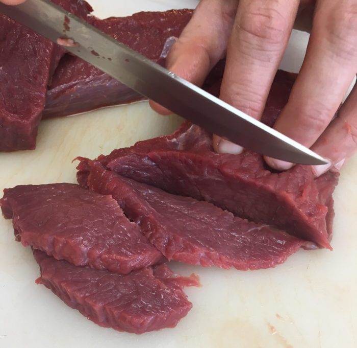 Slicing aoudad meat for tacos